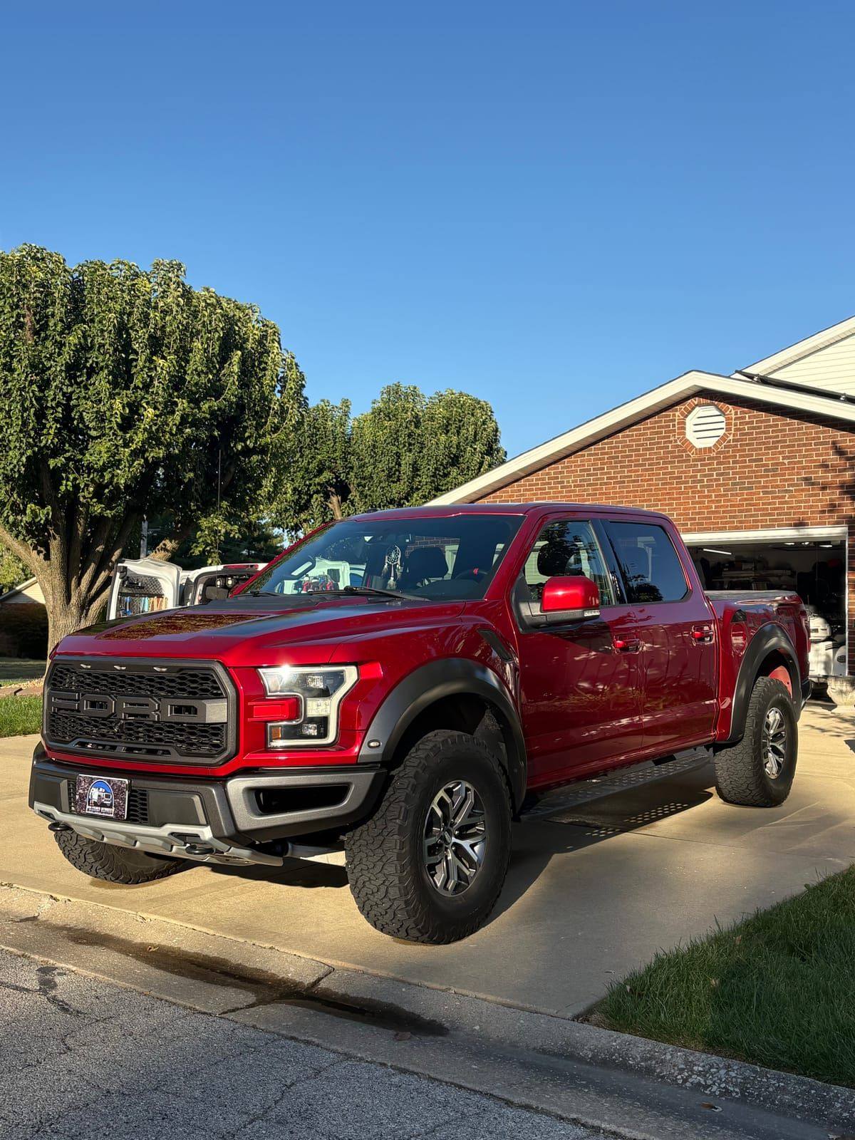 Red Ford F-150 Raptor with deep glossy paint after a full detail in the Metro East